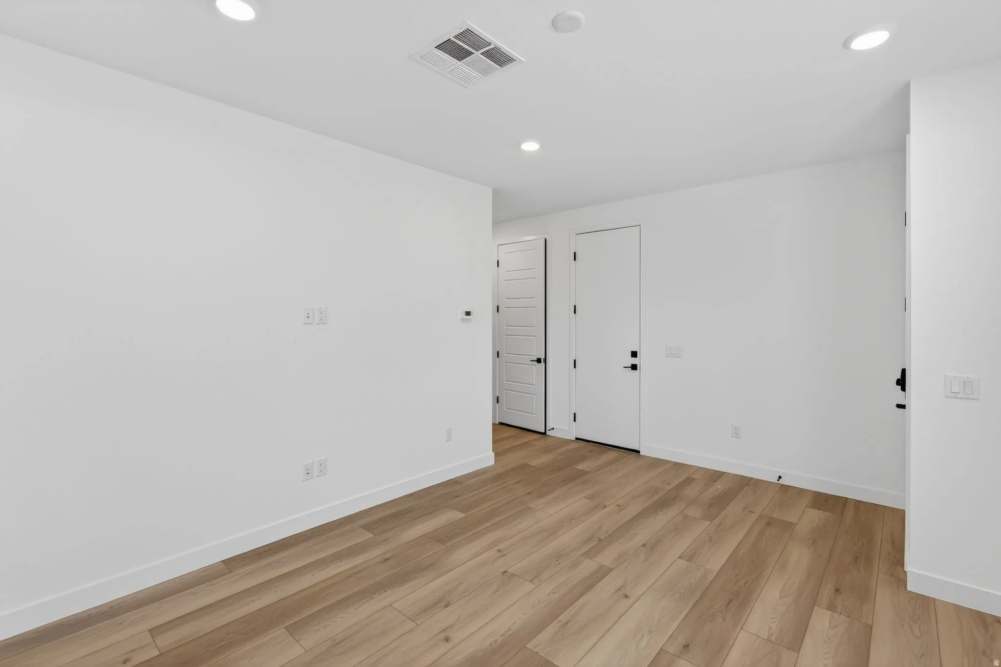 Unfurnished room with light wood finished floors and recessed lighting