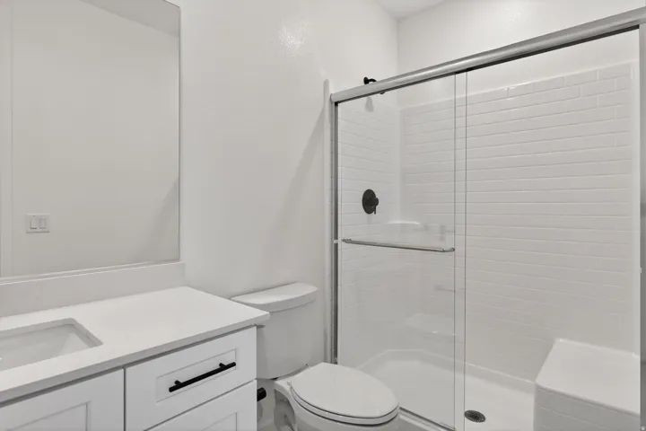 Full bathroom featuring vanity and a stall shower