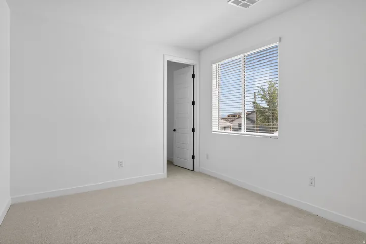 Unfurnished room with light carpet and baseboards