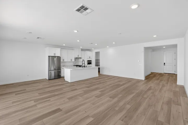 Unfurnished living room with recessed lighting and light wood-style flooring