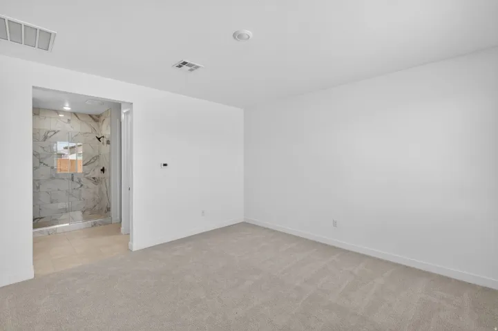 Unfurnished room featuring baseboards and light colored carpet