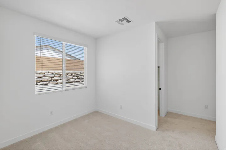 Unfurnished room with light carpet and baseboards