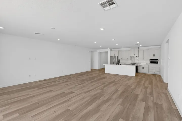 Unfurnished living room with recessed lighting and light wood finished floors