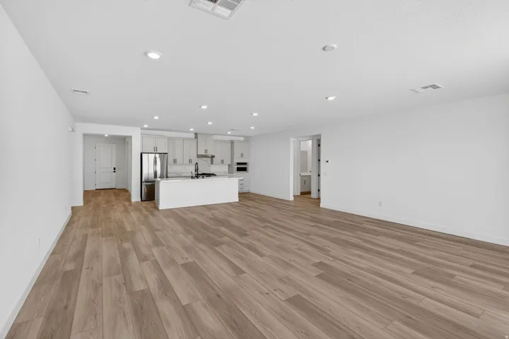 Unfurnished living room featuring light wood-style flooring and recessed lighting