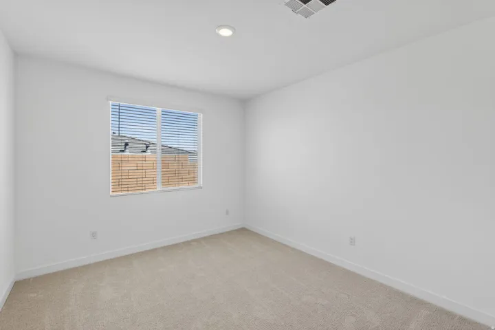 Spare room featuring light colored carpet and recessed lighting