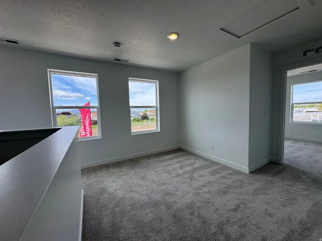 Spare room with carpet flooring and a textured ceiling