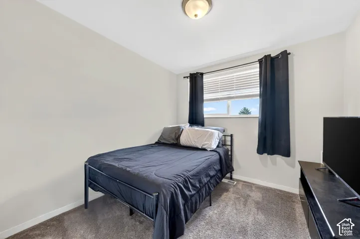 Bedroom with baseboards and carpet floors