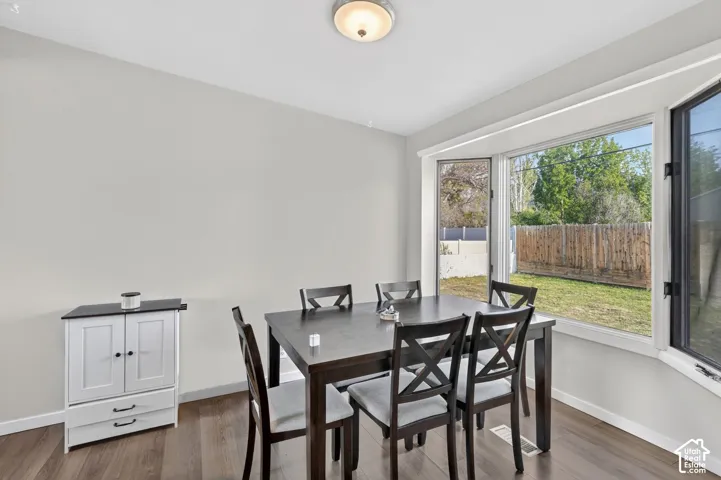 Dining area with dark wood finished floors