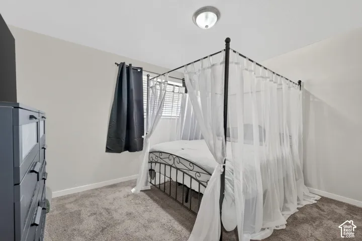 Bedroom with light colored carpet