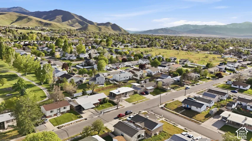 Aerial perspective of suburban area featuring a mountain backdrop