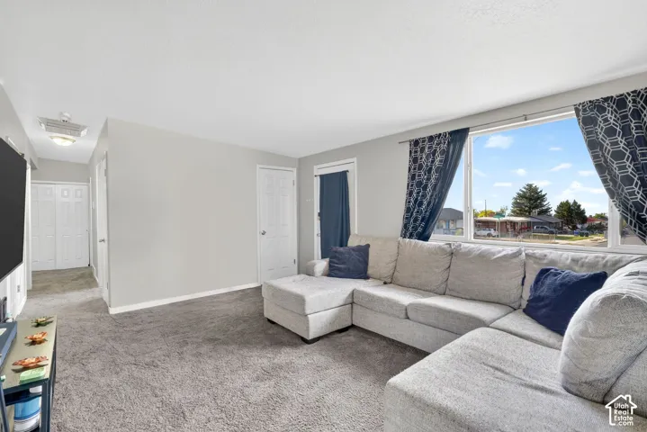 Carpeted living room featuring baseboards