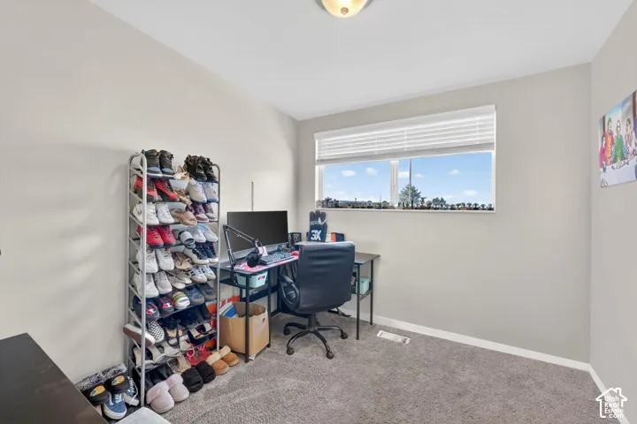 Office space with light carpet and baseboards
