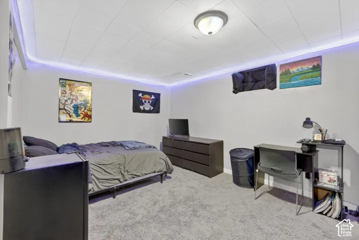 Bedroom featuring carpet floors and baseboards