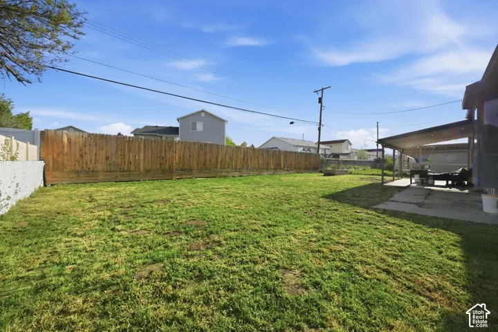 Fenced backyard with a patio