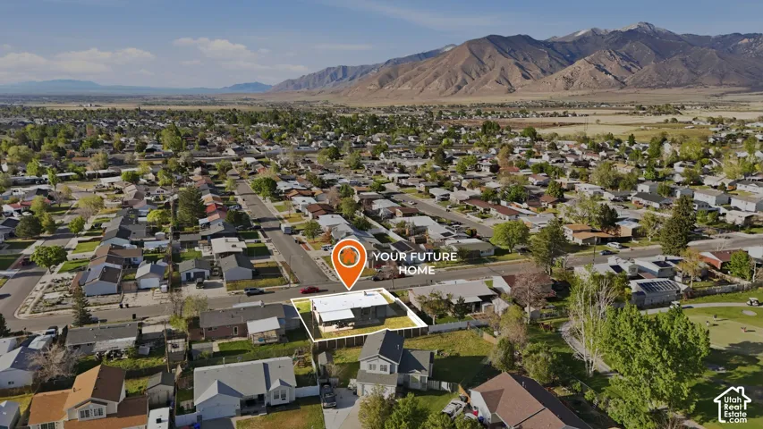 Aerial view of residential area featuring a mountainous background
