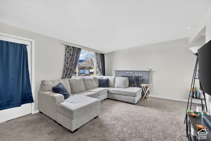 Living room featuring a fireplace and carpet flooring