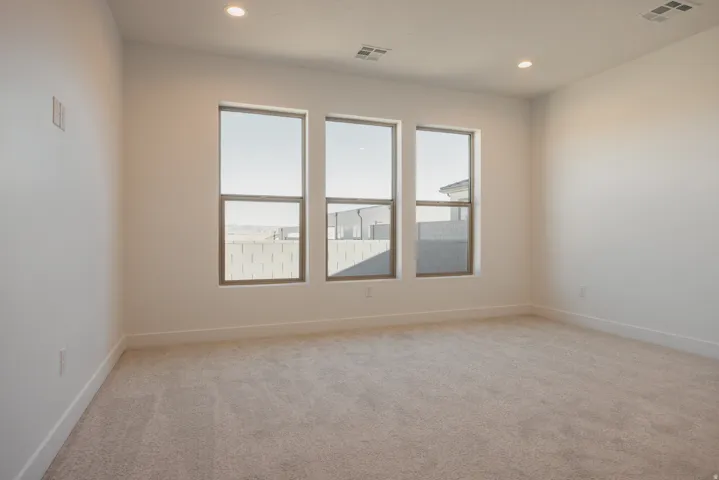Empty room featuring light colored carpet and recessed lighting