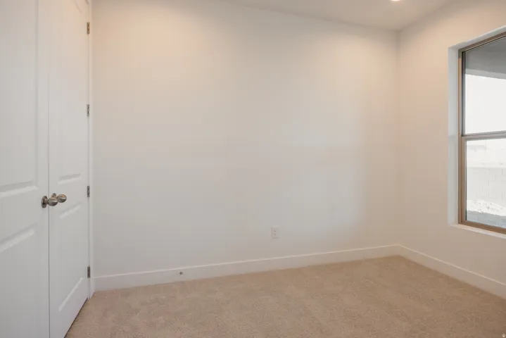 Spare room featuring light carpet and recessed lighting