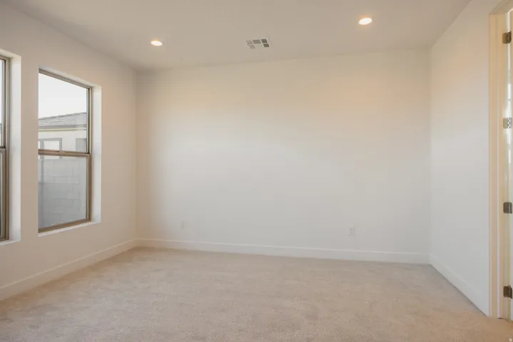 Empty room featuring light carpet and recessed lighting