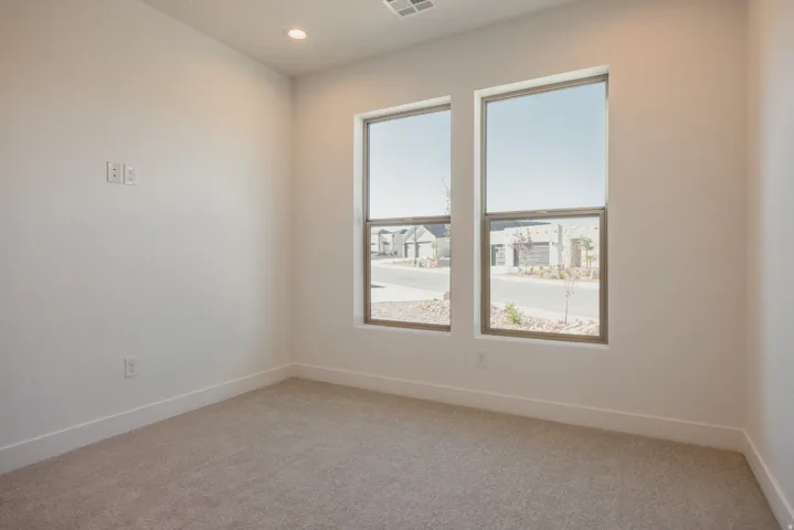 Spare room featuring light colored carpet and recessed lighting