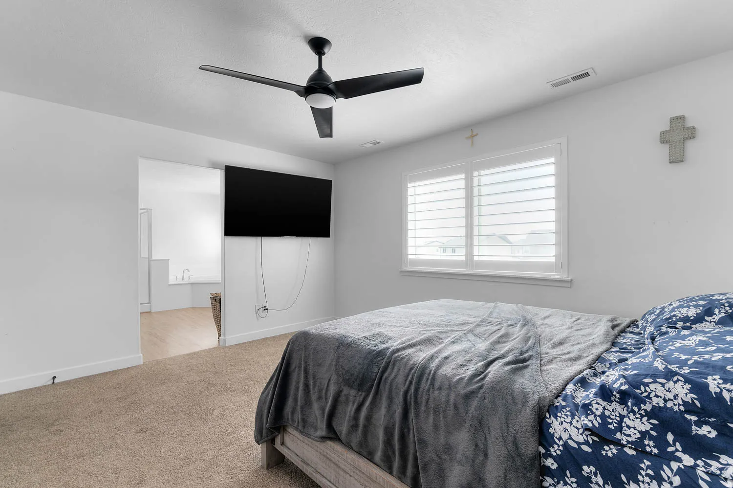 Bedroom featuring a ceiling fan and light colored carpet
