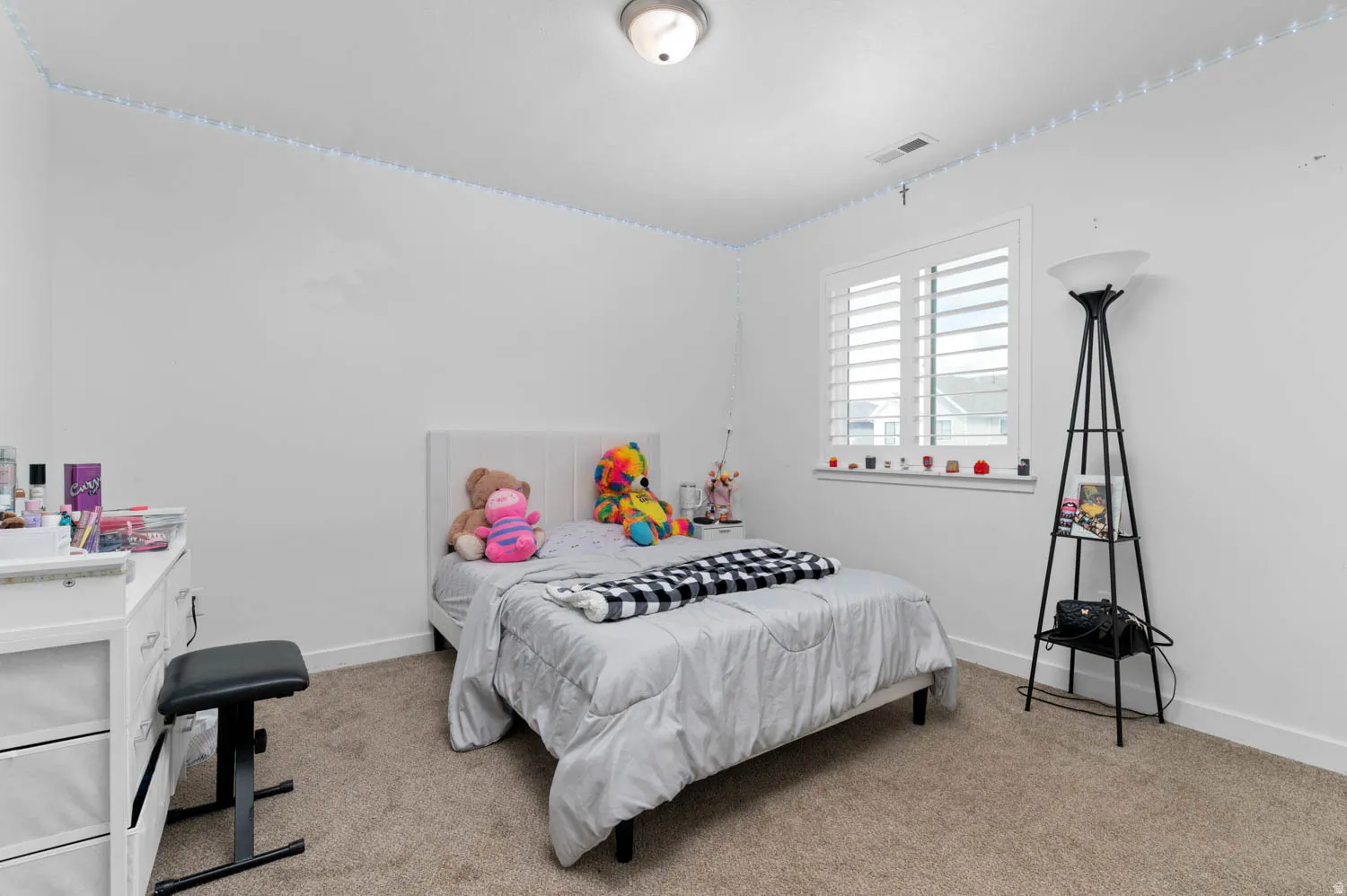 Bedroom featuring light colored carpet