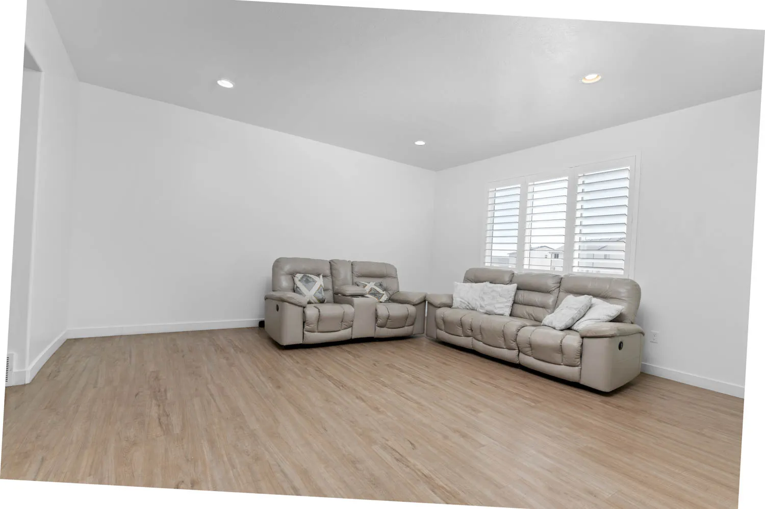 Living area featuring light wood-style floors and recessed lighting
