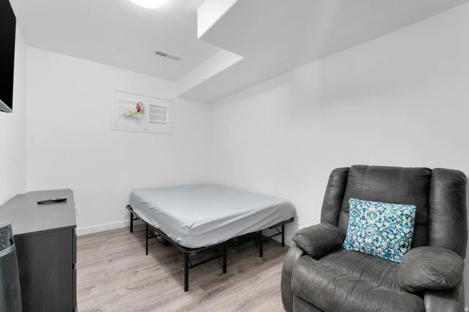 Bedroom with light wood finished floors and baseboards
