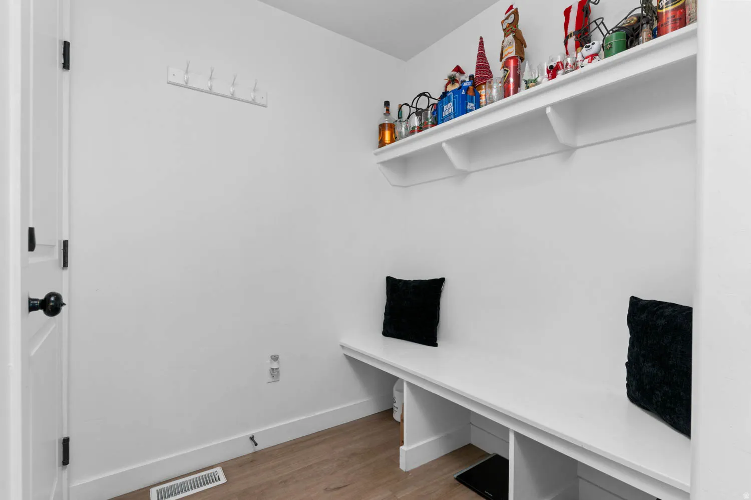 Mudroom featuring light wood-type flooring and baseboards