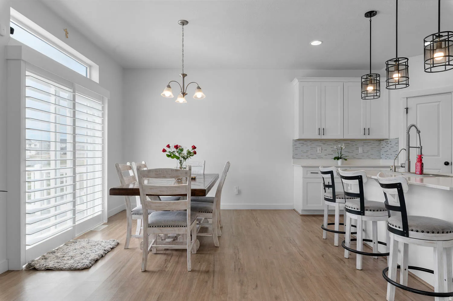 Dining space featuring hanging lights and light wood-type flooring