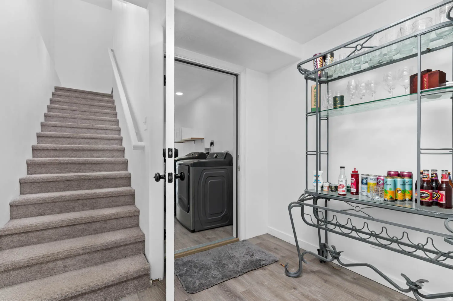Stairs with wood finished floors and independent washer and dryer
