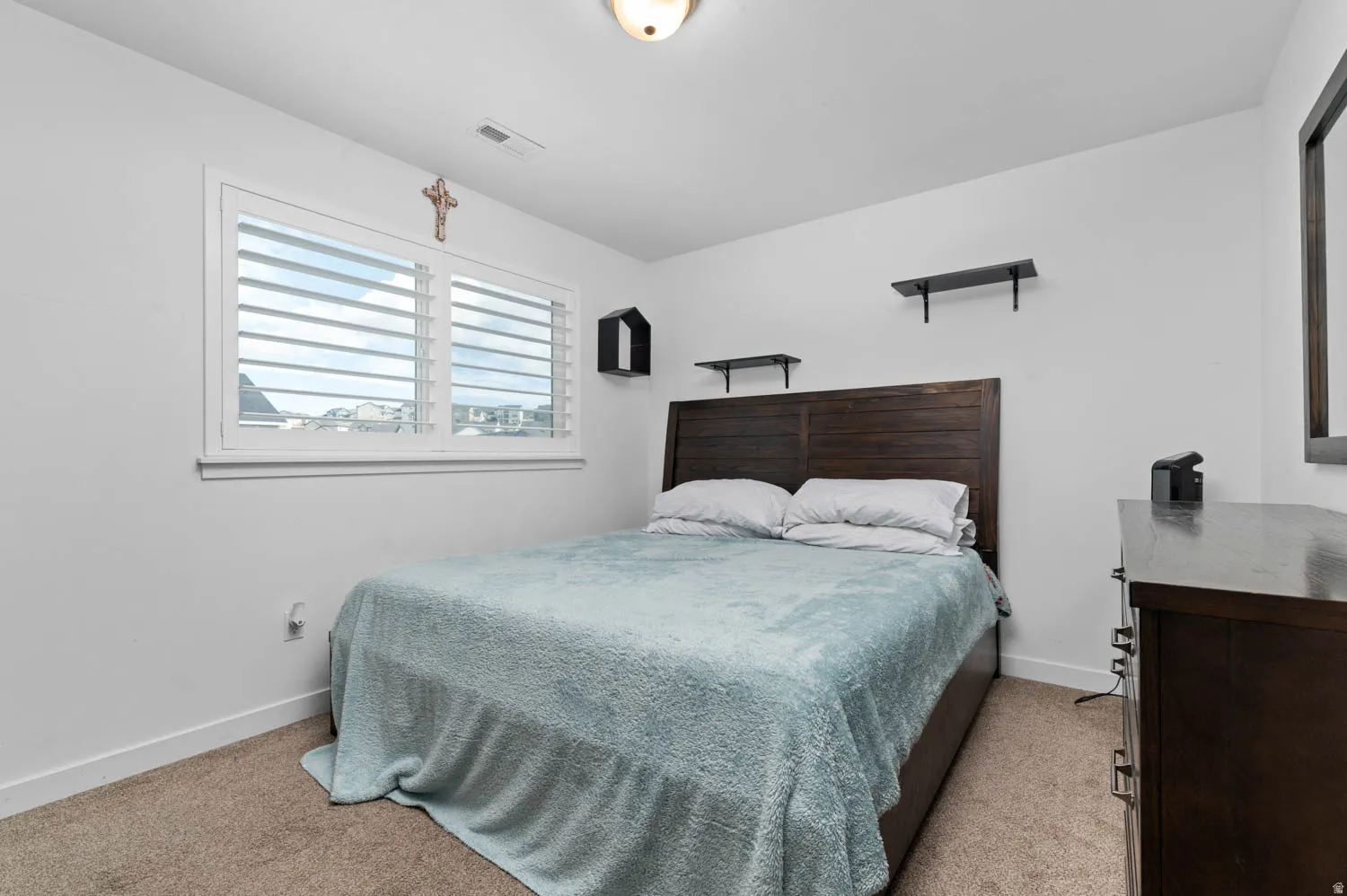 Bedroom with baseboards and light carpet