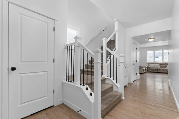 Staircase featuring wood finished floors and baseboards