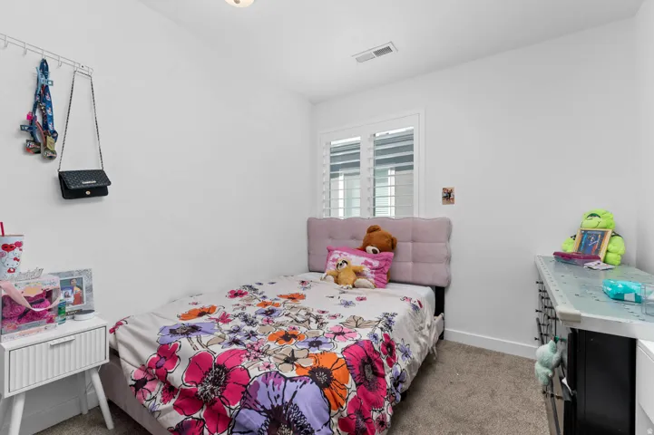 Bedroom with light carpet