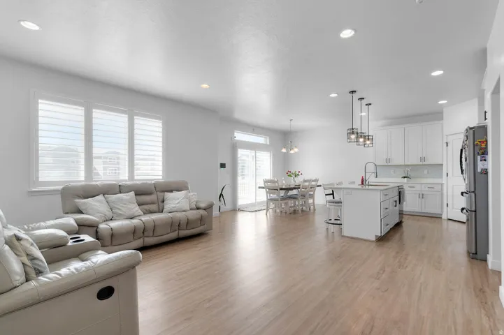 Living room with light wood finished floors and a chandelier