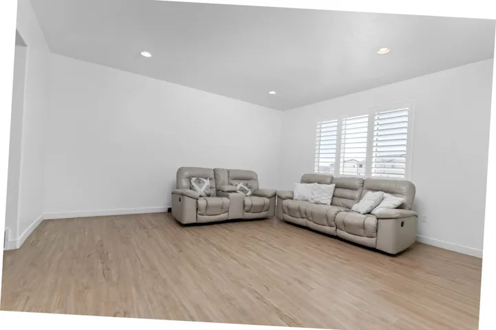 Living area featuring light wood-style floors and recessed lighting