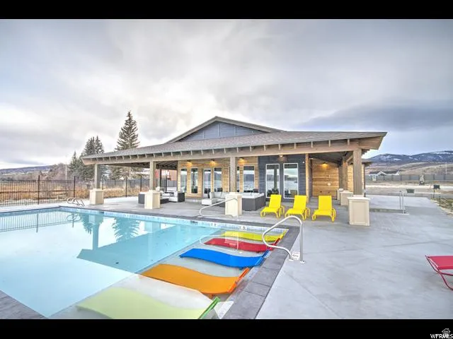 Community pool featuring a patio area and outdoor lounge area