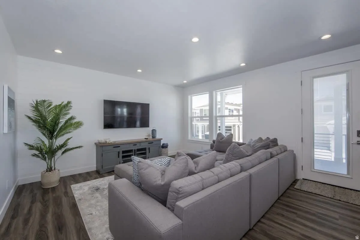 Living room with dark wood-style flooring and recessed lighting