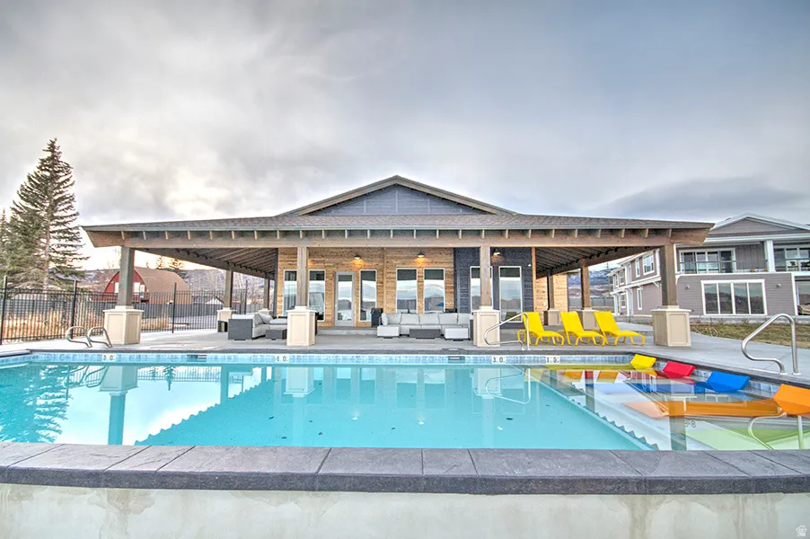 Community pool with outdoor lounge area and a patio area