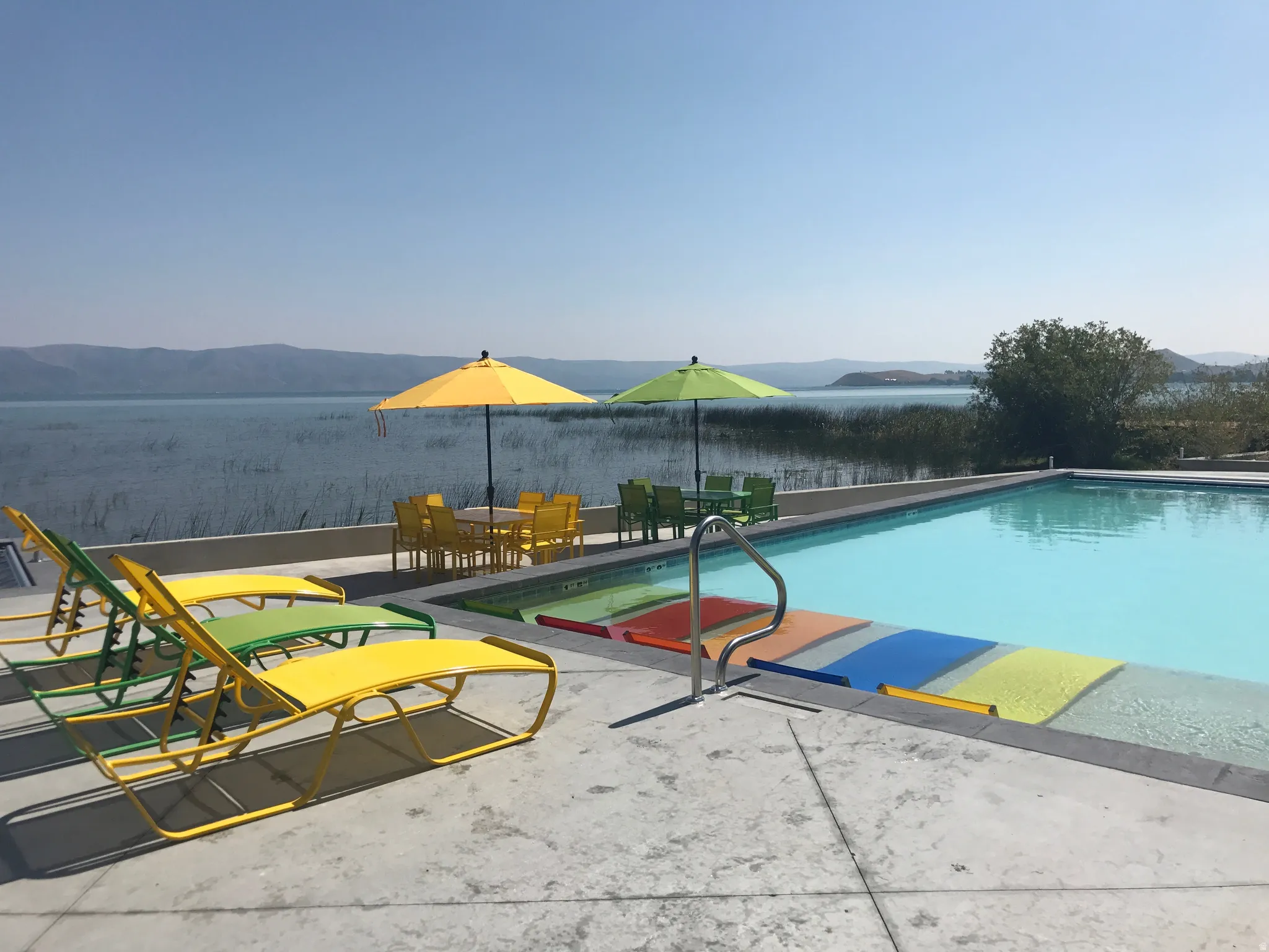 Swimming pool with a mountain view and outdoor dining area
