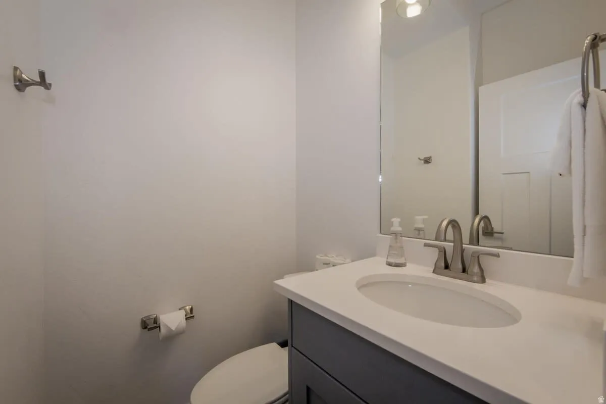 Half bathroom featuring vanity and toilet