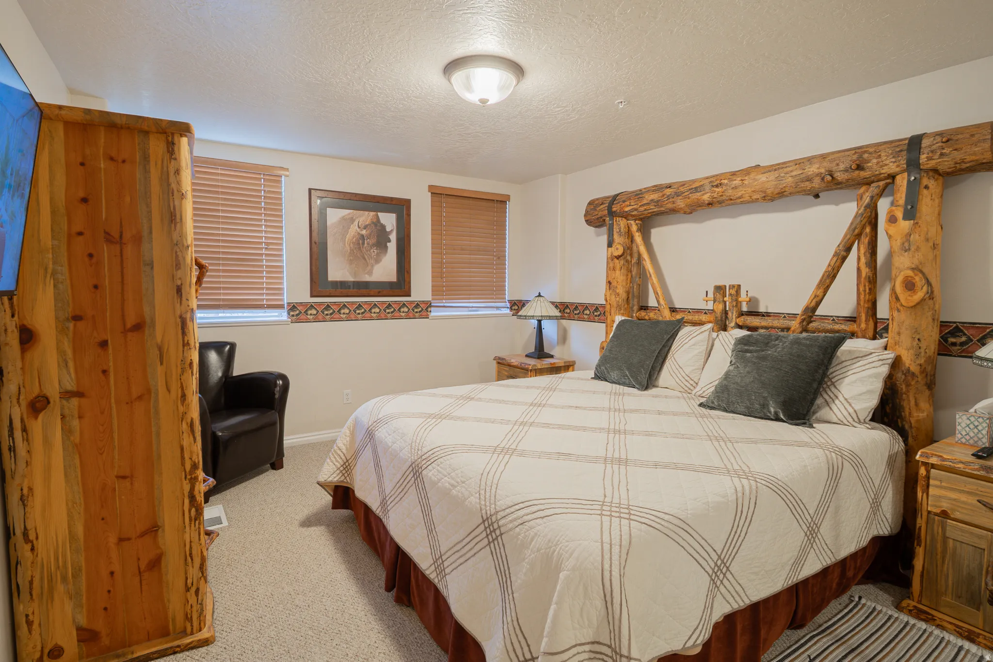 Bedroom with a textured ceiling and carpet