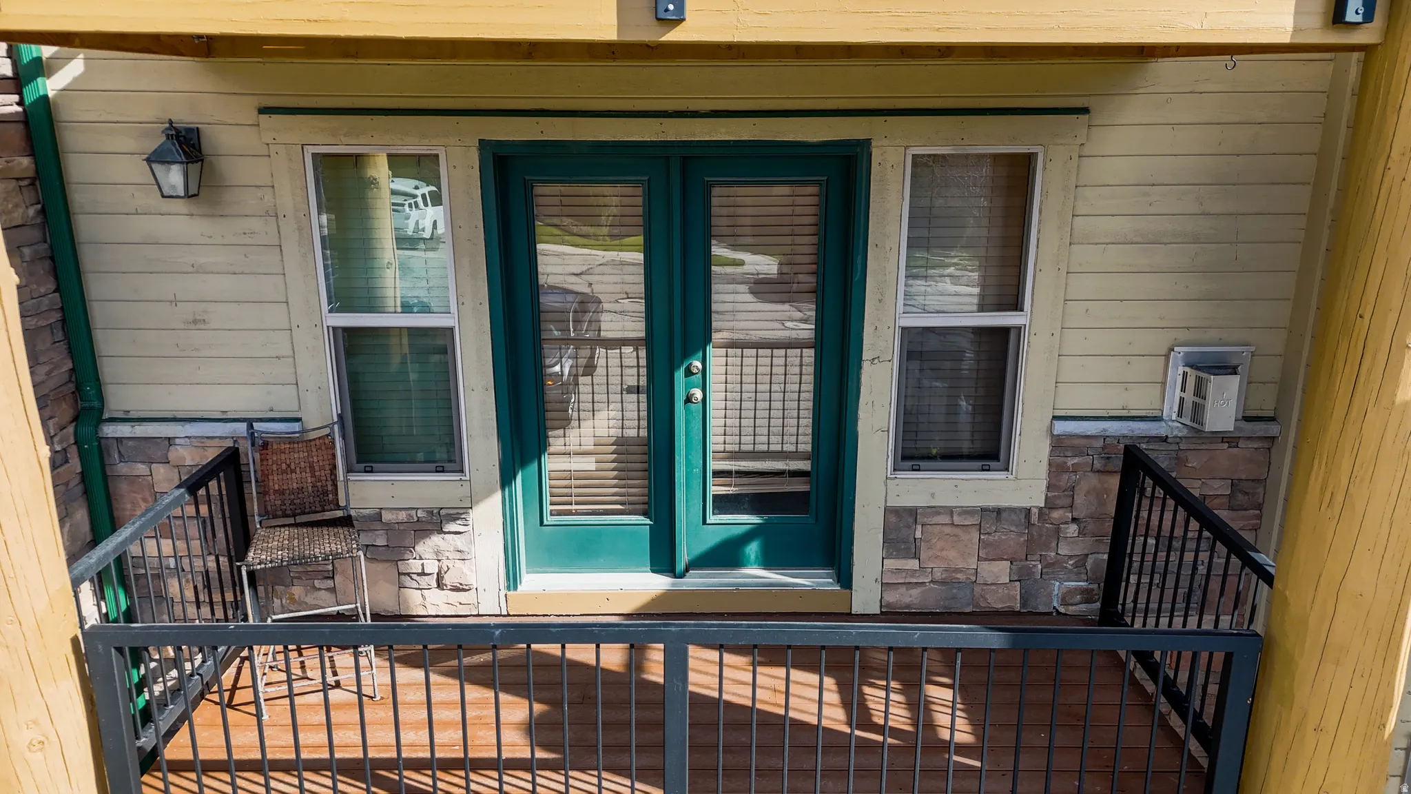 View of exterior entry with stone siding and french doors