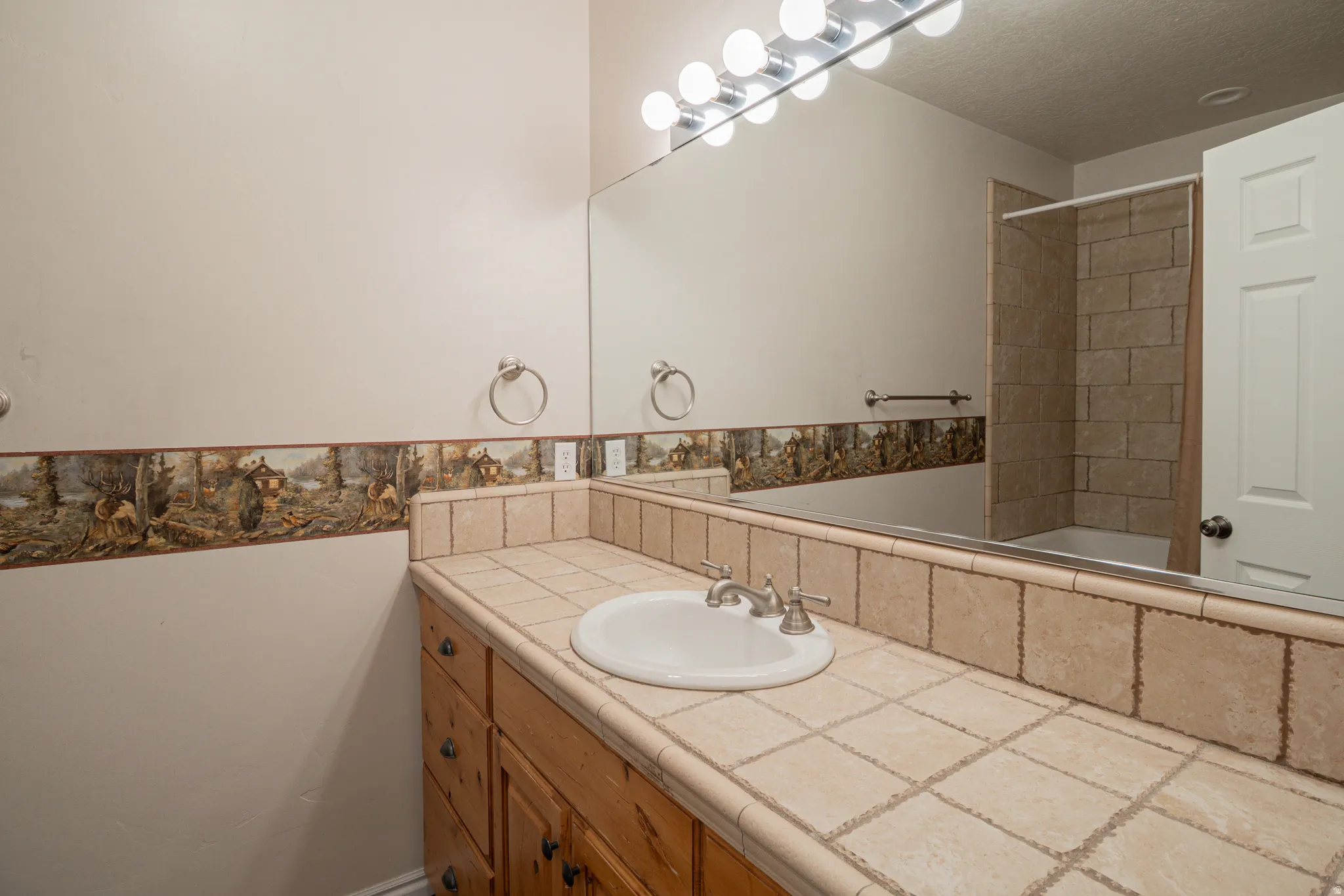 Bathroom with vanity and a textured ceiling