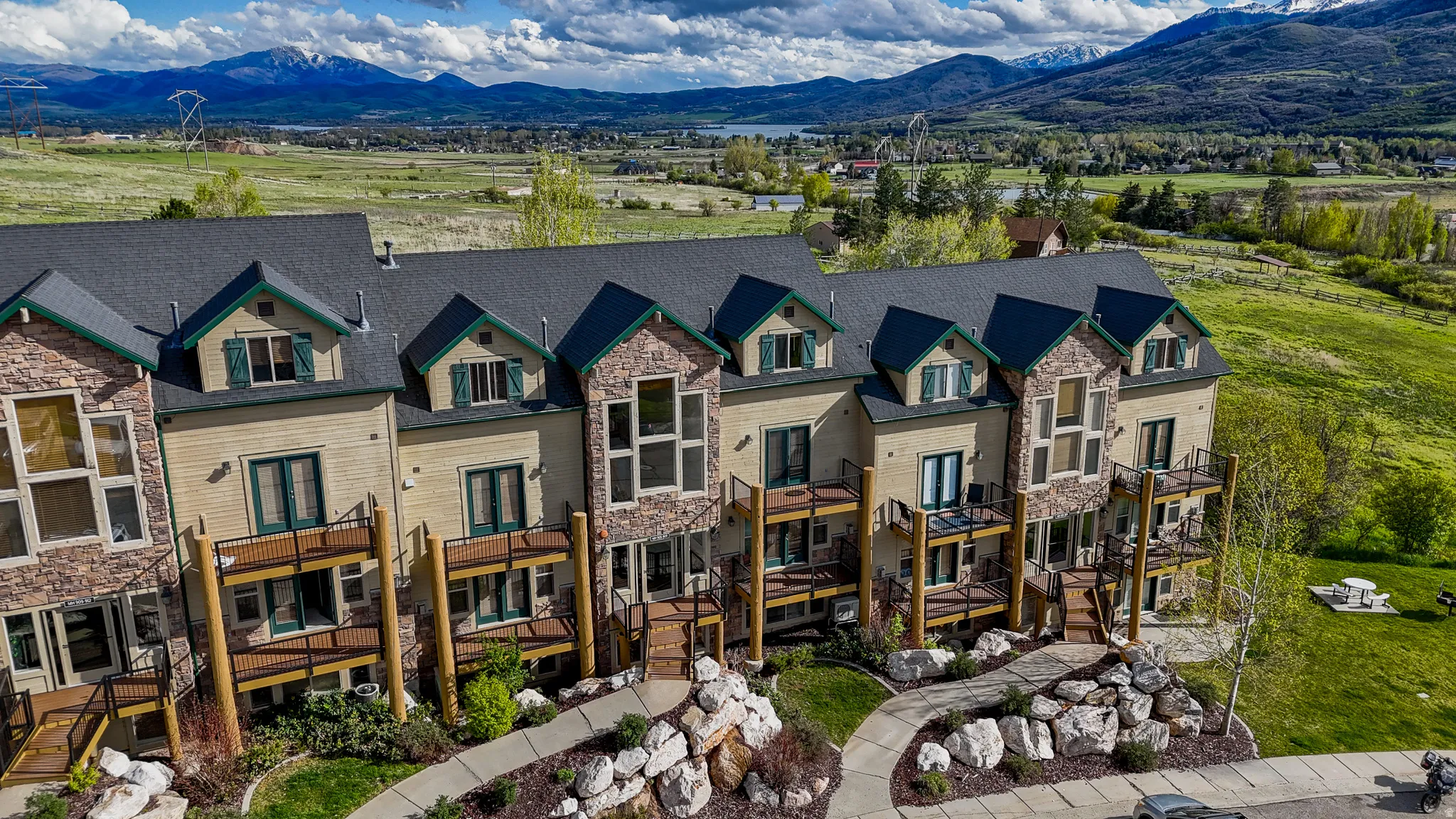 View of front of house featuring a deck with mountain view and stone siding