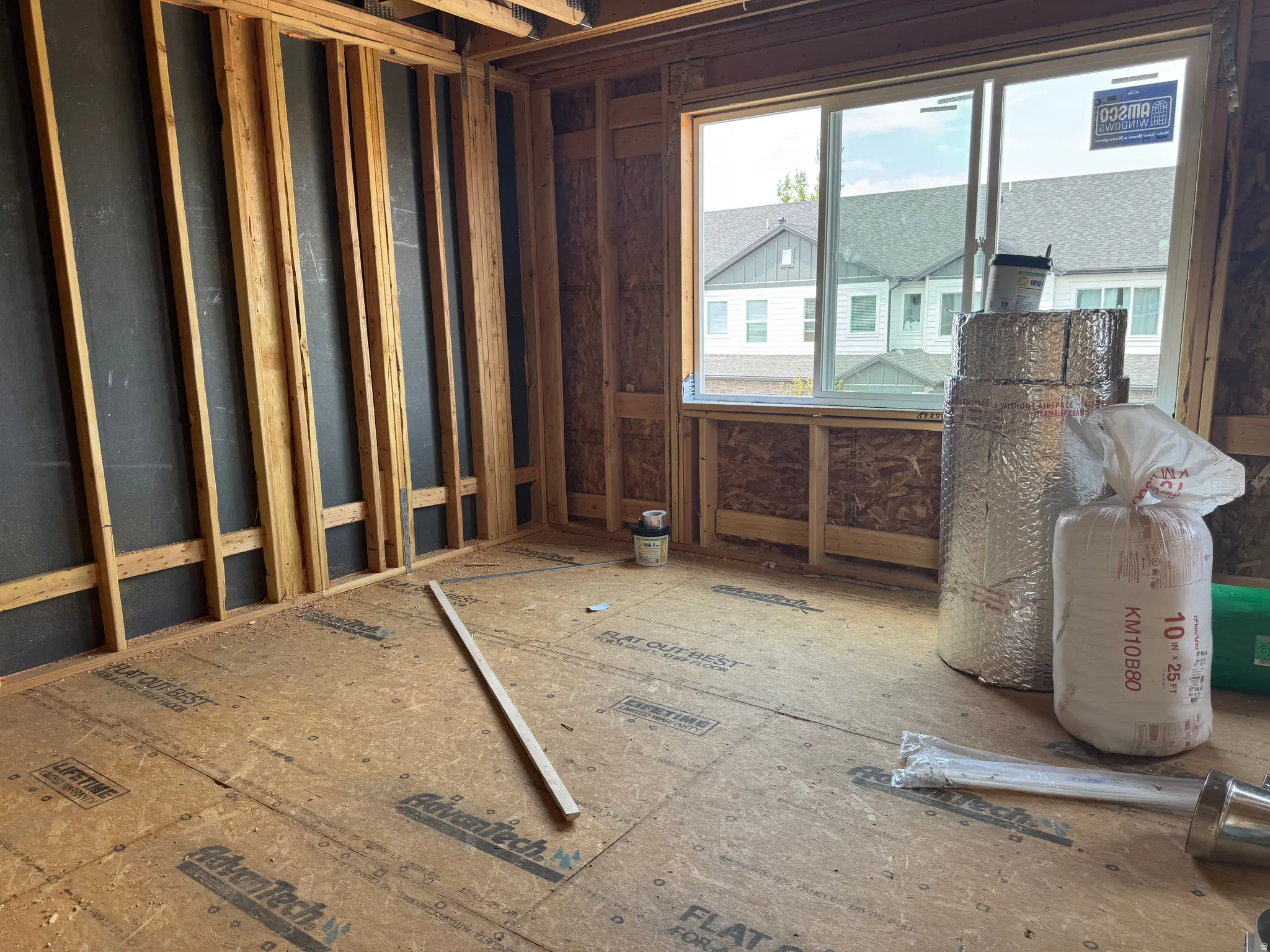 Framed interior space featuring an Advantech subfloor and a large window