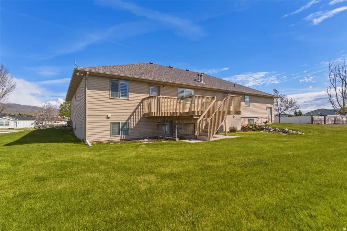 Rear view of property with stairway and a wooden deck