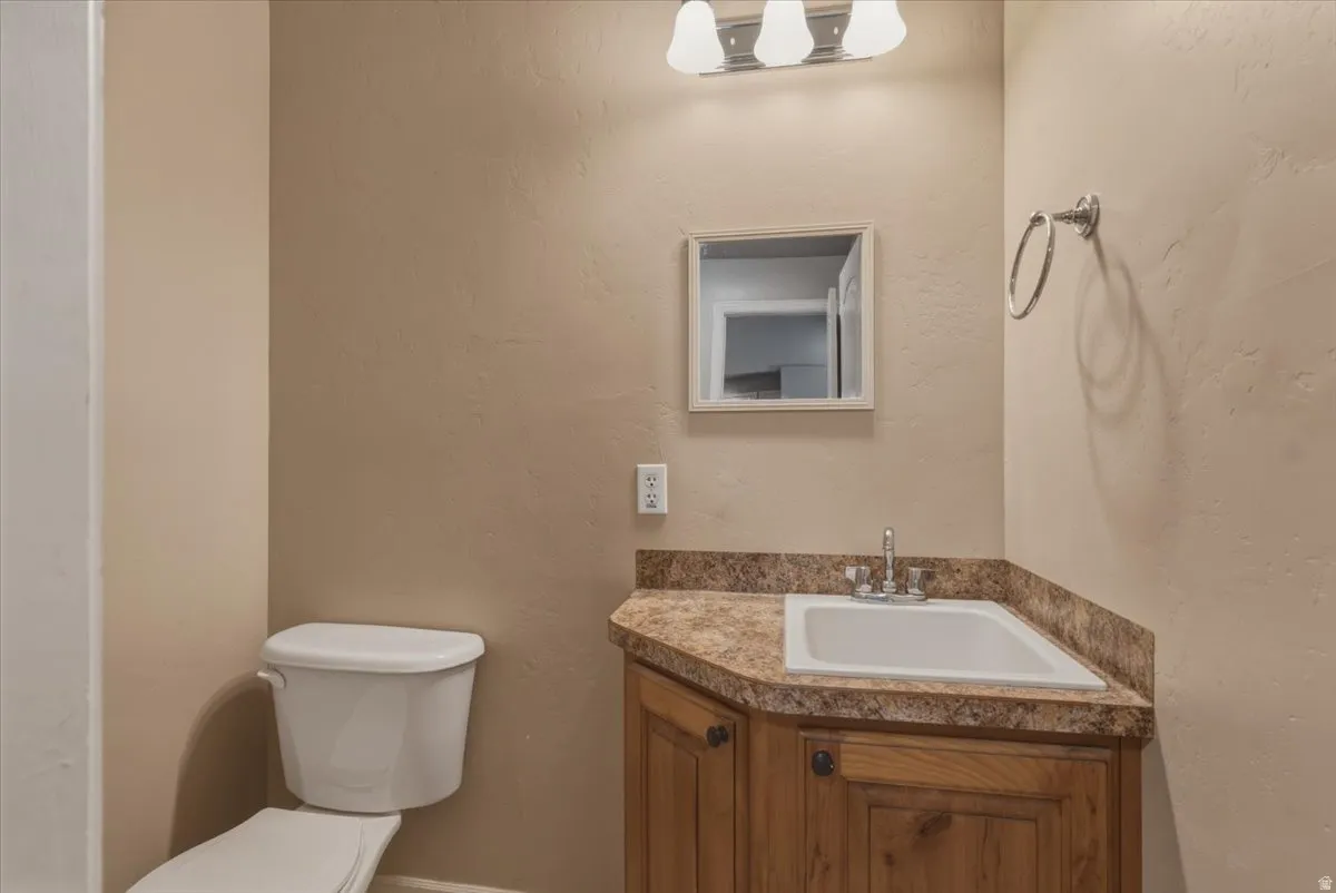 Bathroom featuring vanity and a textured wall