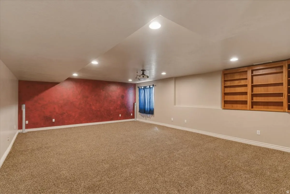 Finished basement with carpet flooring and recessed lighting
