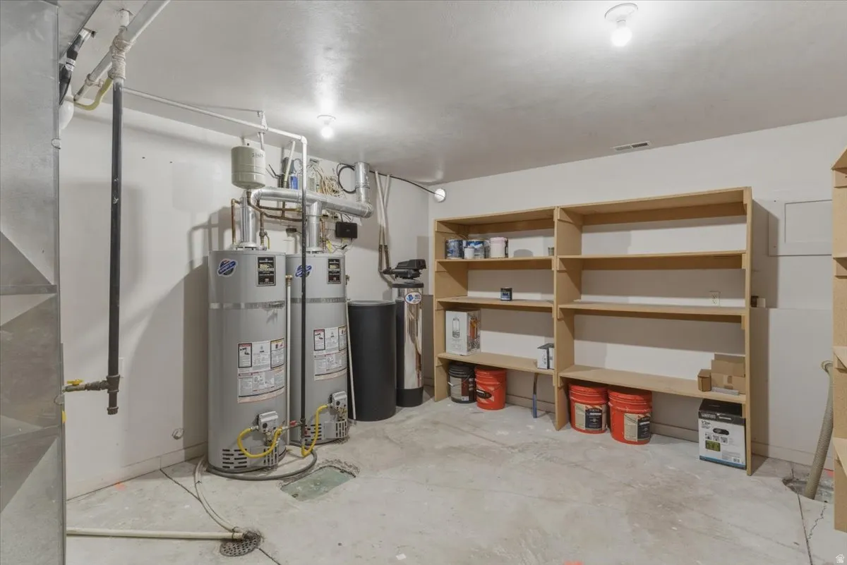 Below grade area with strapped water heater and a water softener system
